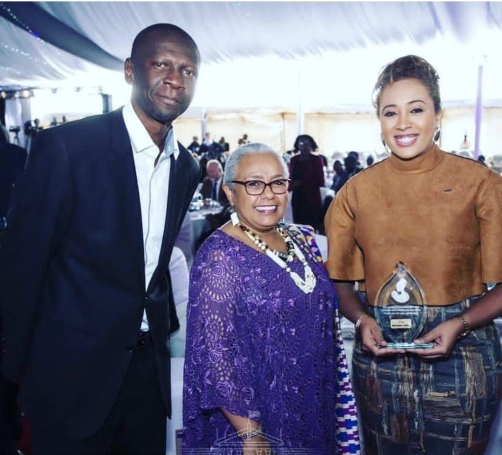 Farida Idris Mohamed receiving an award from First Lady Margaret Kenyatta